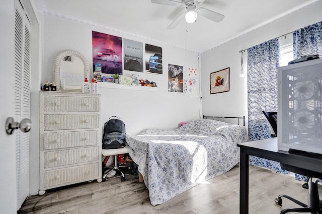 bedroom with ceiling fan and wood finished floors