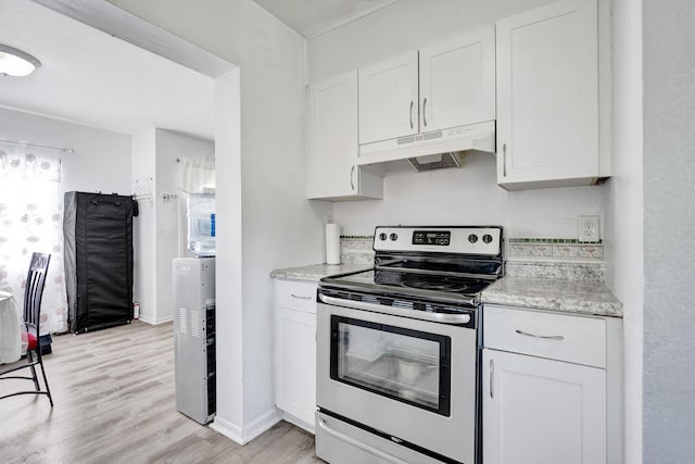 kitchen featuring electric stove, light wood-style floors, white cabinets, light stone countertops, and under cabinet range hood