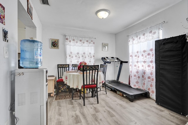 exercise area with visible vents and wood finished floors