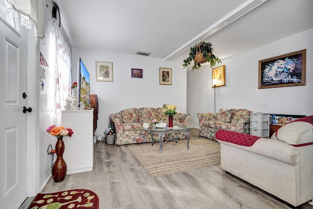 living room featuring wood finished floors and visible vents