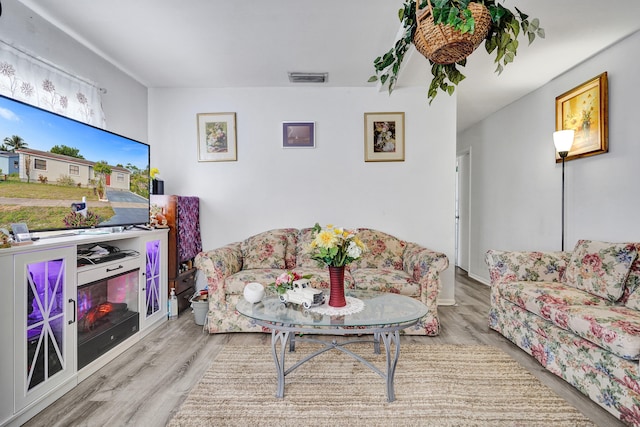 living room with visible vents and wood finished floors