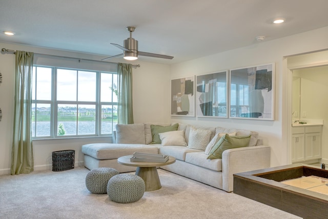 carpeted living area with recessed lighting, ceiling fan, and baseboards