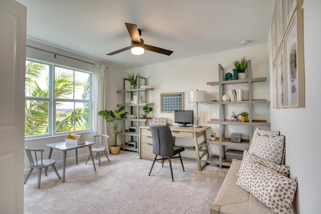 carpeted office featuring ceiling fan