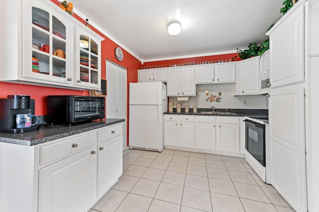 kitchen with glass insert cabinets, white appliances, light tile patterned flooring, and white cabinets