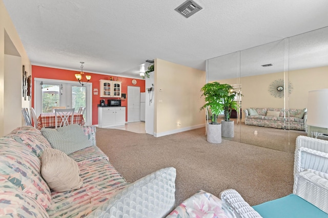 carpeted living room with visible vents and a textured ceiling