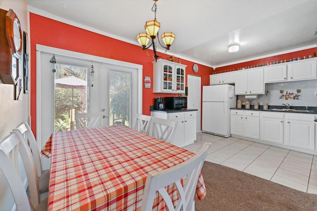 dining room featuring light tile patterned floors and an inviting chandelier