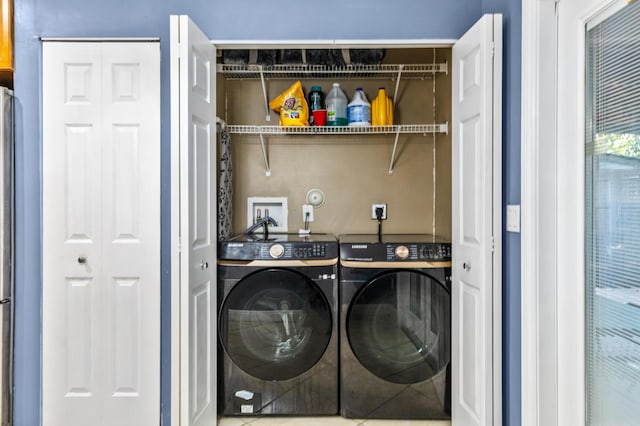 clothes washing area with laundry area and washer and clothes dryer