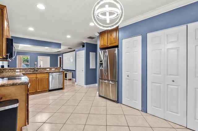 kitchen featuring brown cabinetry, stainless steel appliances, and light tile patterned flooring