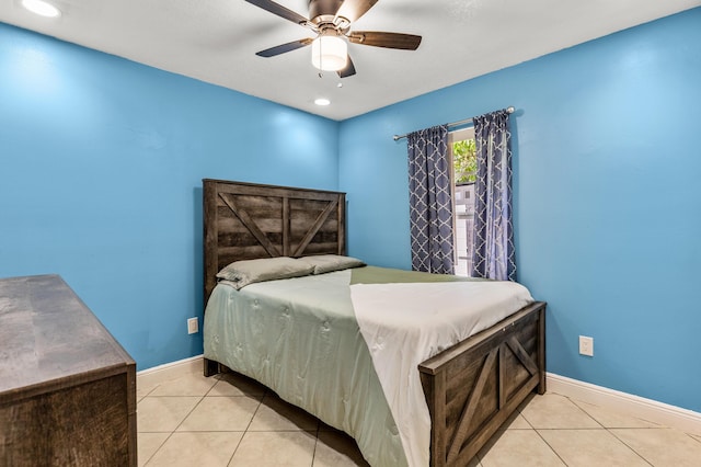 bedroom with a ceiling fan, baseboards, and light tile patterned floors