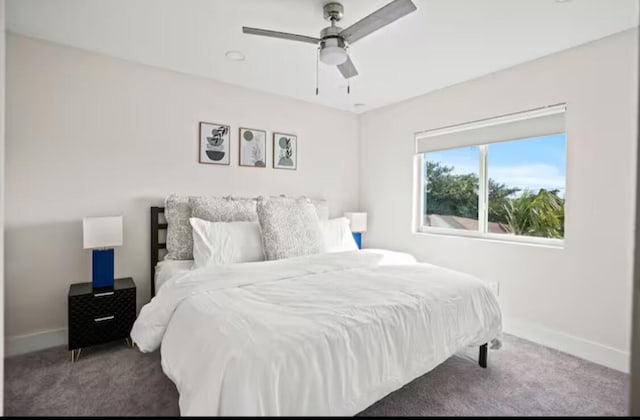 bedroom with carpet floors, baseboards, and a ceiling fan