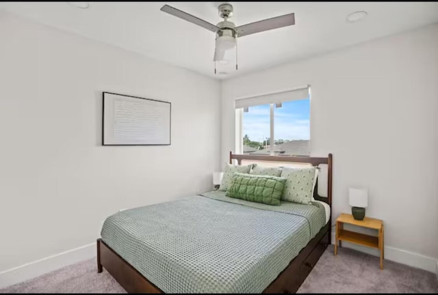 bedroom with light carpet, ceiling fan, and baseboards