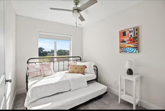 carpeted bedroom with a ceiling fan and baseboards