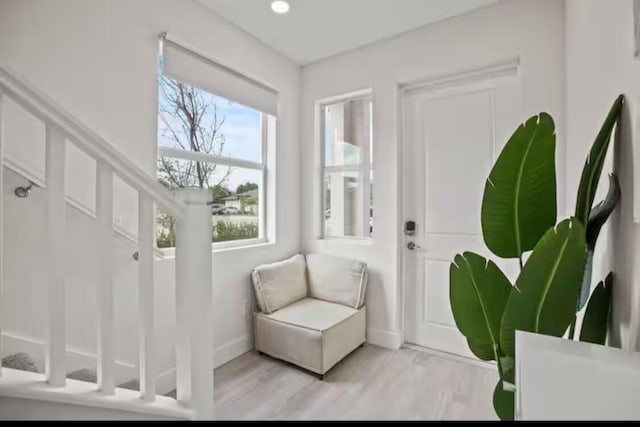 entryway featuring baseboards and light wood finished floors