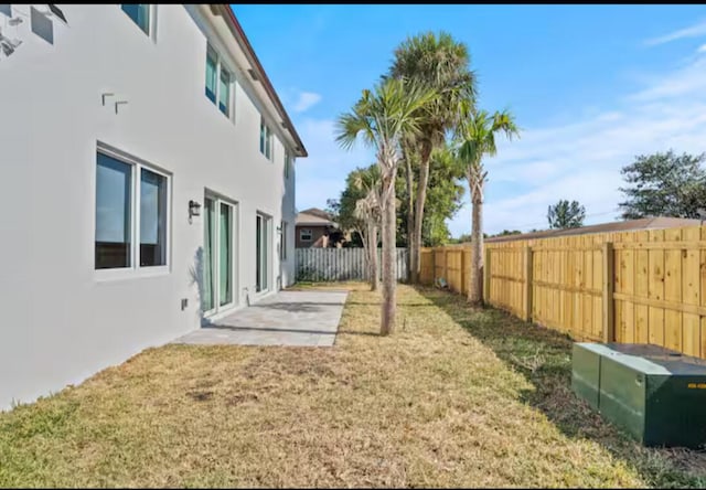 view of yard featuring a patio area and a fenced backyard