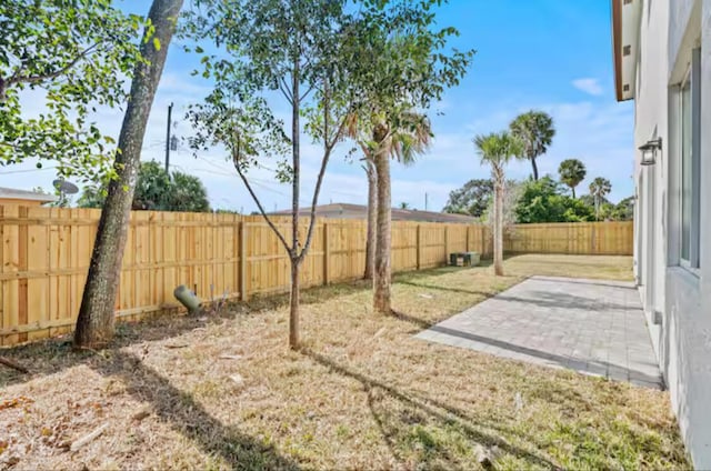 view of yard with a patio and a fenced backyard