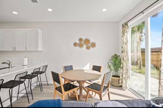 dining room featuring recessed lighting and light wood-style flooring