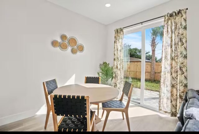 dining room featuring baseboards and light wood finished floors