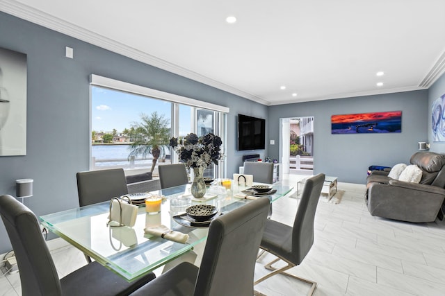 dining area with baseboards, crown molding, and recessed lighting