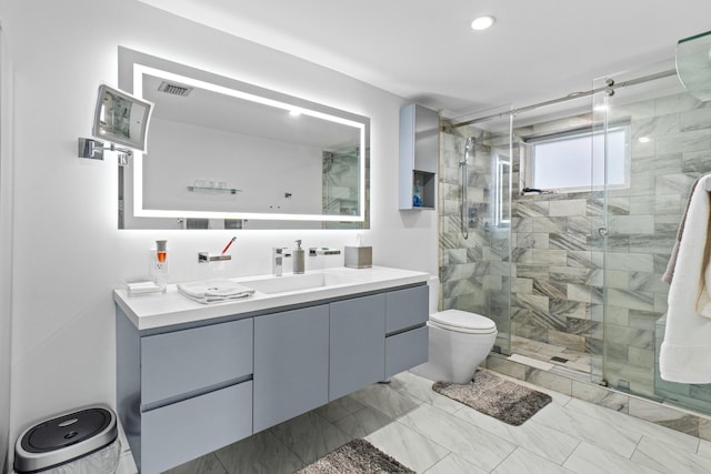 bathroom featuring toilet, vanity, visible vents, marble finish floor, and a shower stall