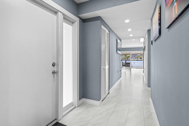 corridor featuring recessed lighting and baseboards