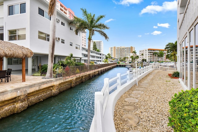 view of water feature with fence and a city view