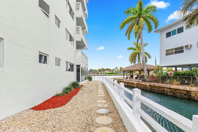 exterior space featuring a water view, fence, and a gazebo