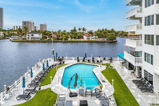 pool with a water view, a view of city, a dock, and a patio