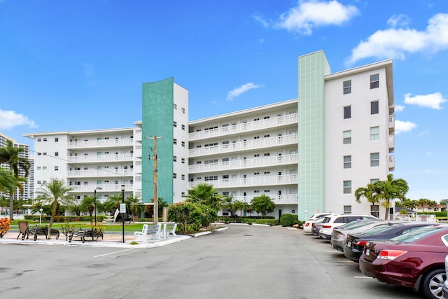 view of building exterior featuring uncovered parking