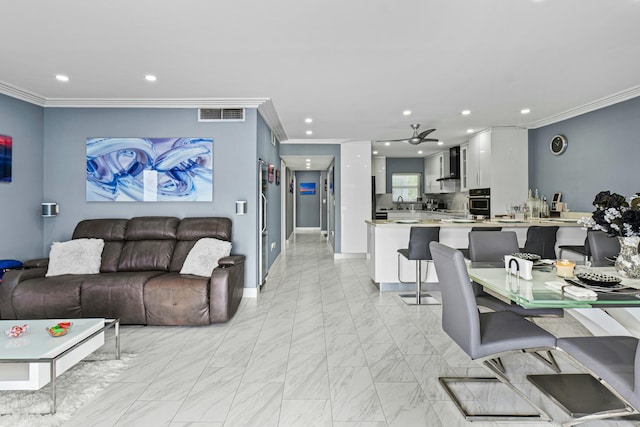 living area featuring baseboards, recessed lighting, visible vents, and crown molding