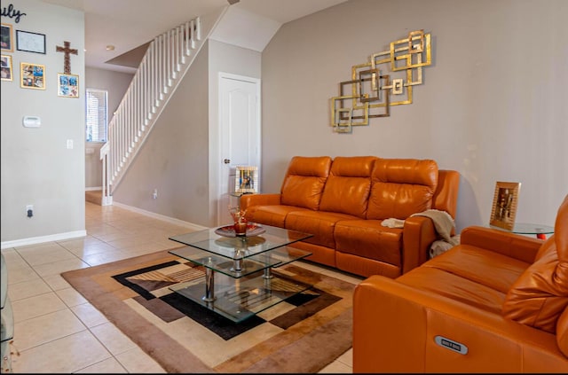 living room with stairway, baseboards, and light tile patterned floors