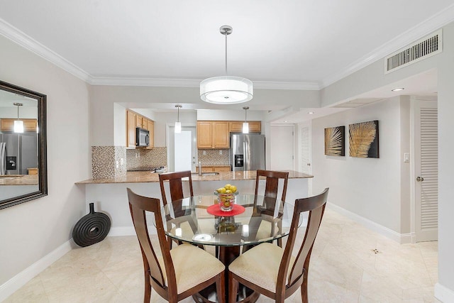 dining space with ornamental molding, visible vents, and baseboards