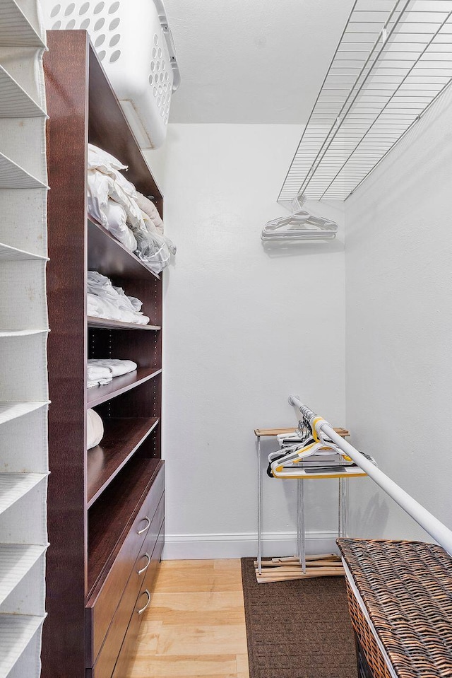 walk in closet featuring wood finished floors