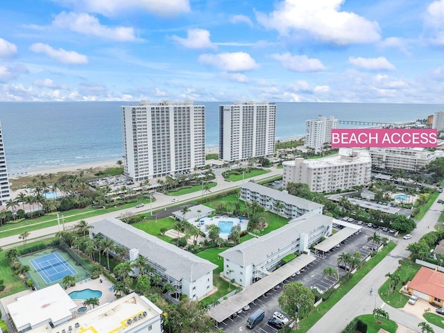 birds eye view of property with a view of city and a water view