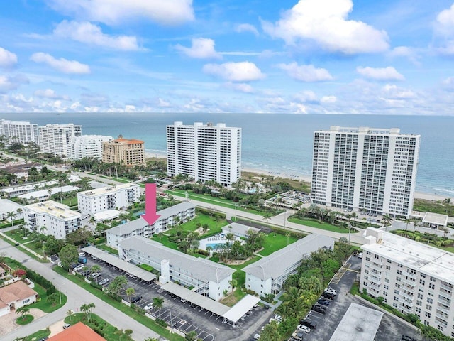 birds eye view of property with a water view and a city view