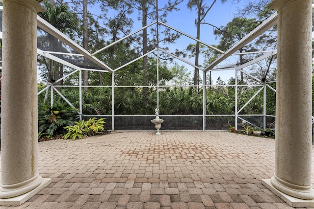 view of patio with glass enclosure