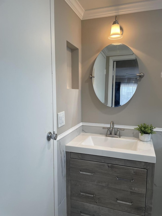 bathroom with crown molding and vanity