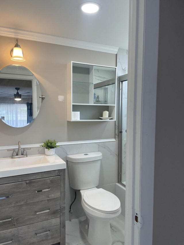 full bath with marble finish floor, ornamental molding, vanity, and toilet