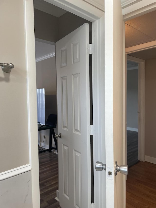 hall with dark wood-style floors and baseboards