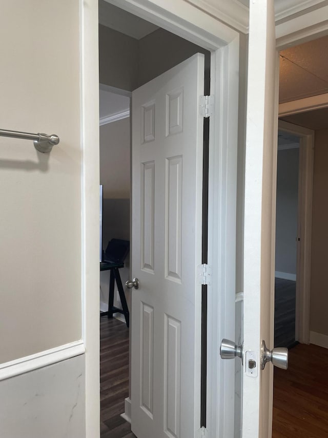 hallway with baseboards and wood finished floors