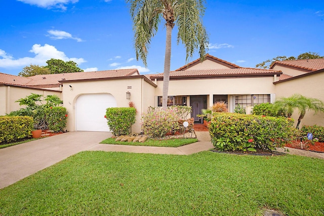 mediterranean / spanish home with a tile roof, stucco siding, an attached garage, driveway, and a front lawn