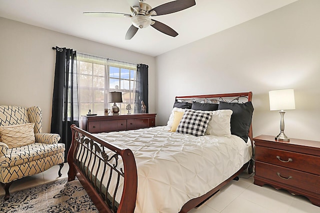 tiled bedroom featuring ceiling fan