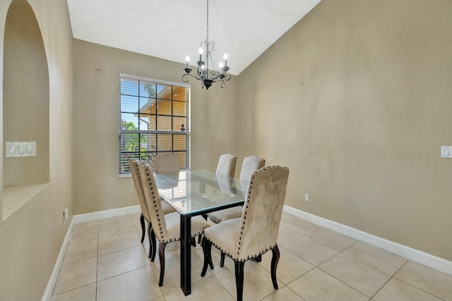 961 SW Haas Ave, Port Saint Lucie, FL 34953 - dining space with a chandelier, arched walkways, vaulted ceiling, and light tile patterned flooring