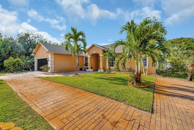 961 SW Haas Ave, Port Saint Lucie, FL 34953 - view of front of home with stucco siding, driveway, a front yard, and a garage