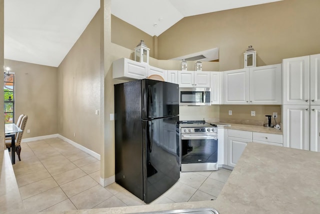 961 SW Haas Ave, Port Saint Lucie, FL 34953 - kitchen with light tile patterned floors, white cabinetry, stainless steel appliances, and light countertops