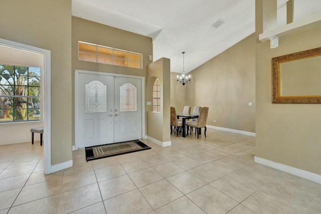 961 SW Haas Ave, Port Saint Lucie, FL 34953 - entrance foyer featuring light tile patterned flooring, an inviting chandelier, high vaulted ceiling, and visible vents