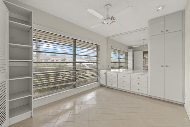 interior space featuring a ceiling fan and light tile patterned floors