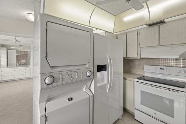 kitchen with a textured ceiling, under cabinet range hood, white appliances, light countertops, and stacked washing maching and dryer