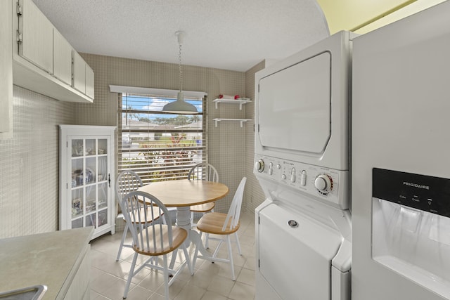 dining space with light tile patterned floors and a textured ceiling