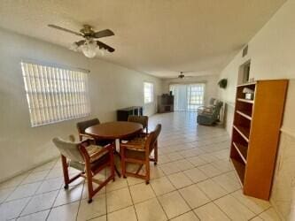 dining room featuring visible vents, light tile patterned flooring, and a ceiling fan