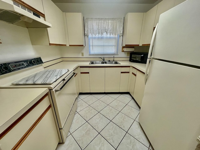 kitchen with white appliances, under cabinet range hood, light countertops, and a sink